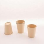 Set of biodegradable paper cups on a neutral background, highlighting eco-friendly design.